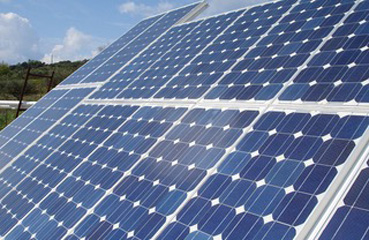 A close up photo of some solar PV panels represent reducing emissions using renewable energy technology